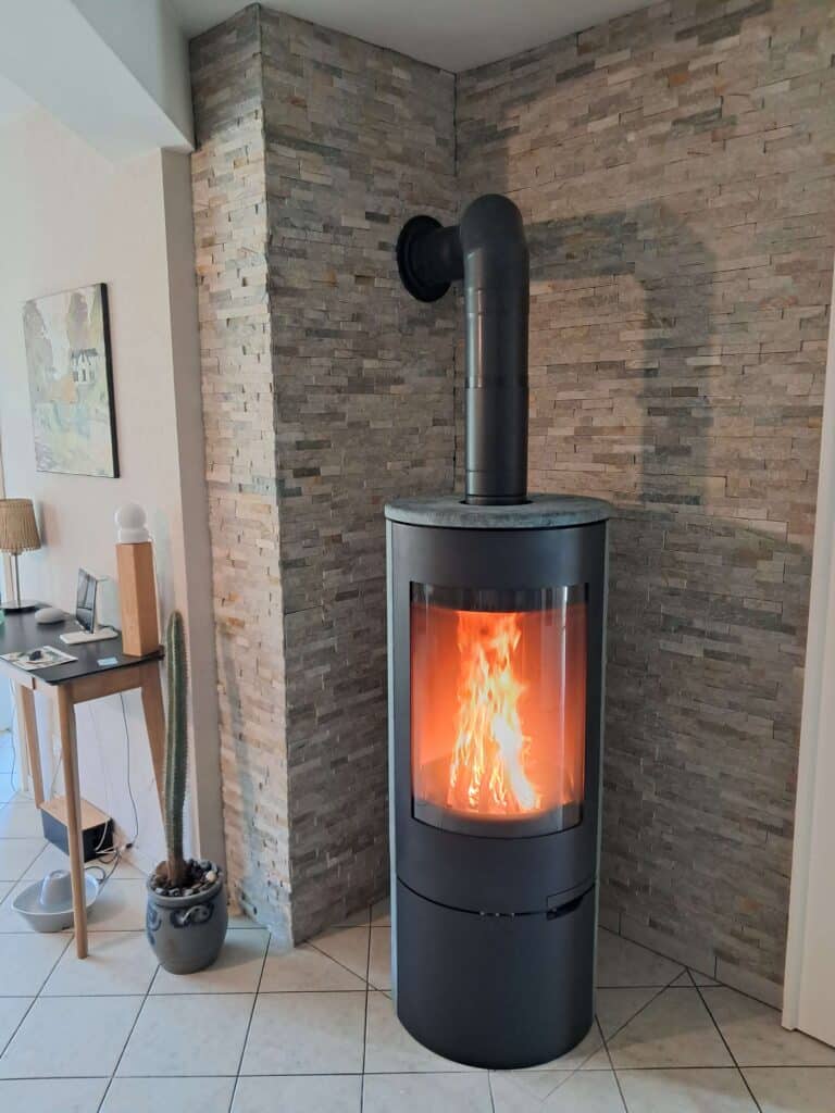 Bûches en flammes à l’intérieur d’un poêle à bois en fonctionnement.