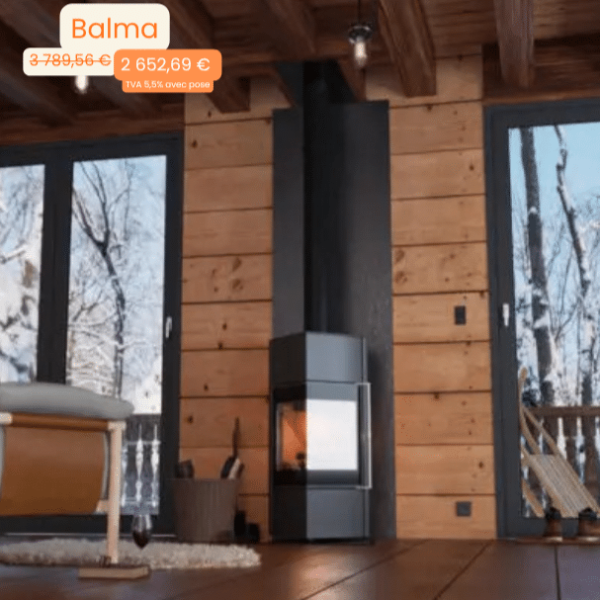 Modern metal wood stove in a cozy wooden cabin living room with large glass doors and a snowy outdoors view.